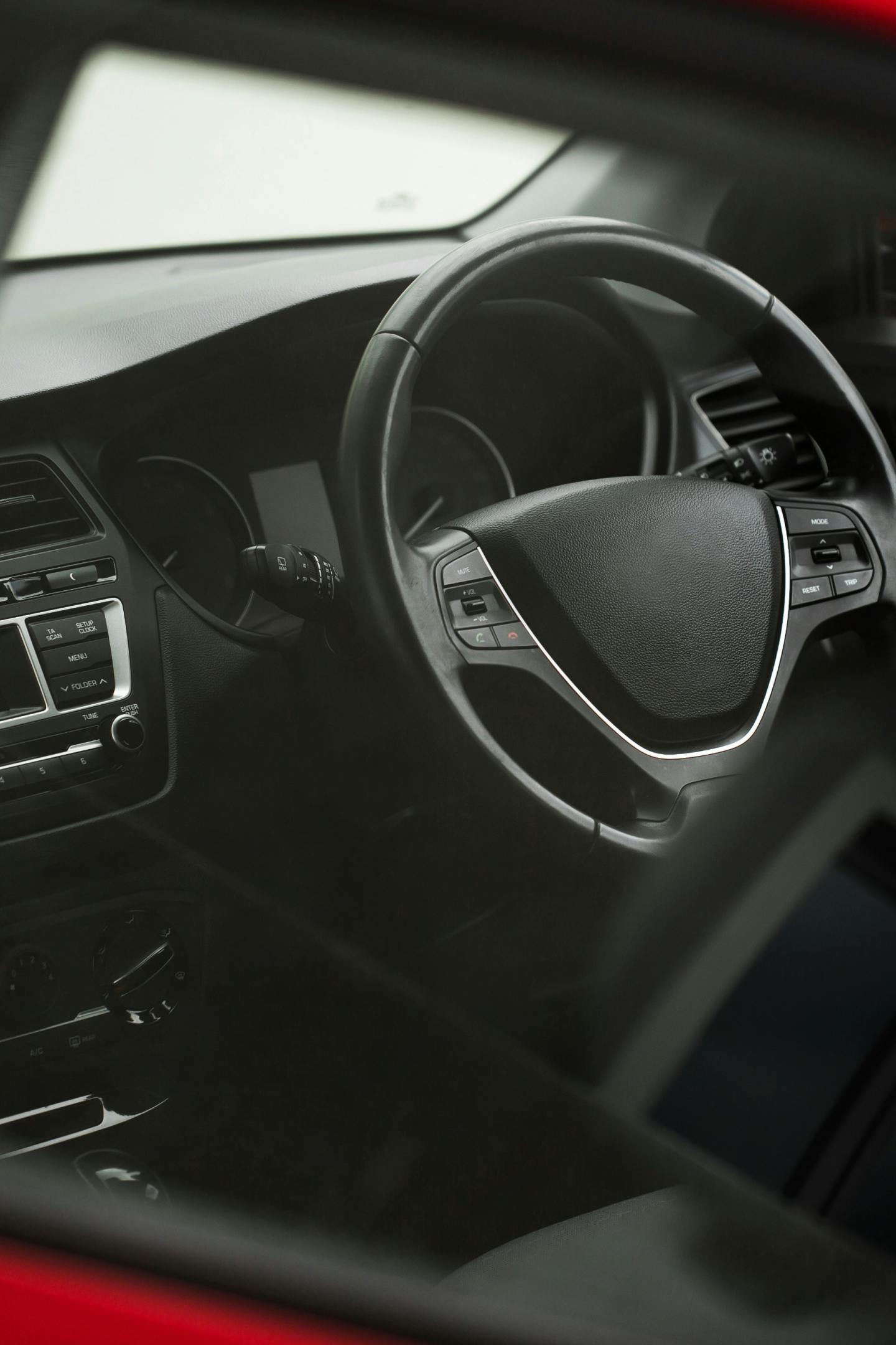 Image of a car interior focusing on the steering wheel