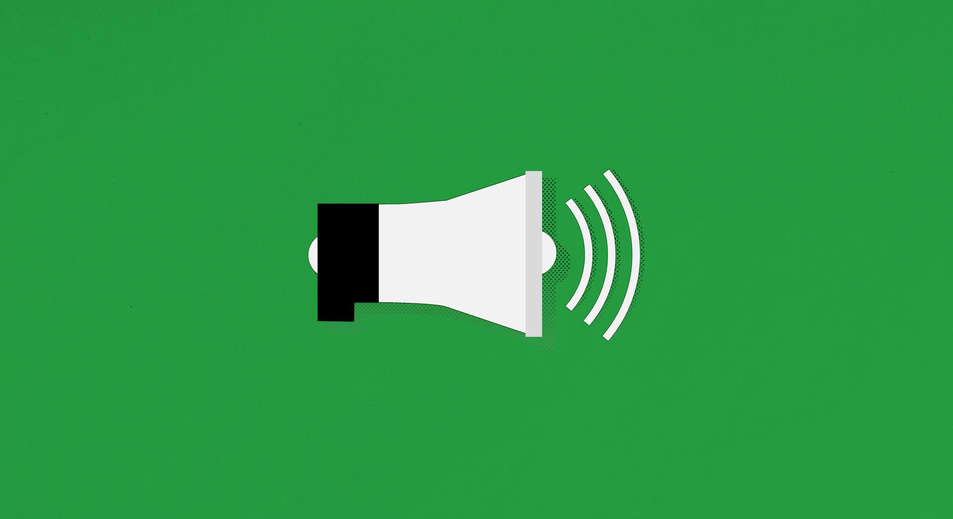 A megaphone on a green background with an indication of sound