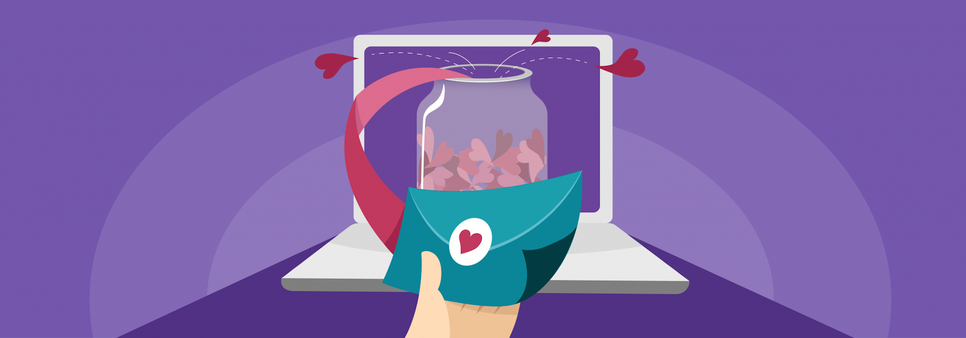 A jar containing love hearts perched on a laptop with someone holding an envelope in the foreground. 