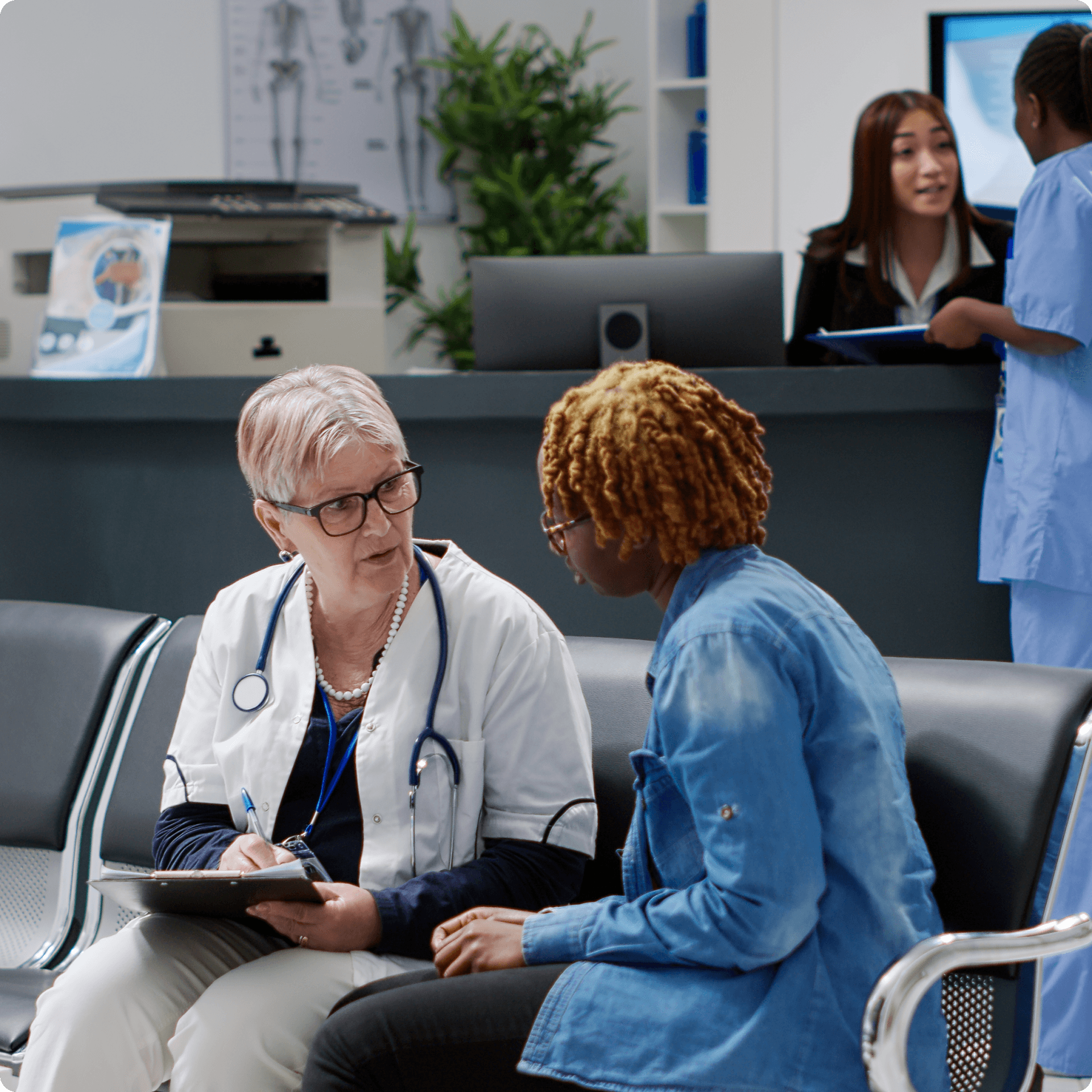 A medical professional is interacting with a patient, both are seated.