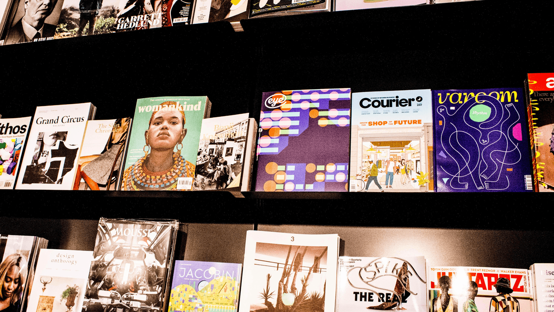 A display of various magazines across two shelves A display of various magazines across two shelves