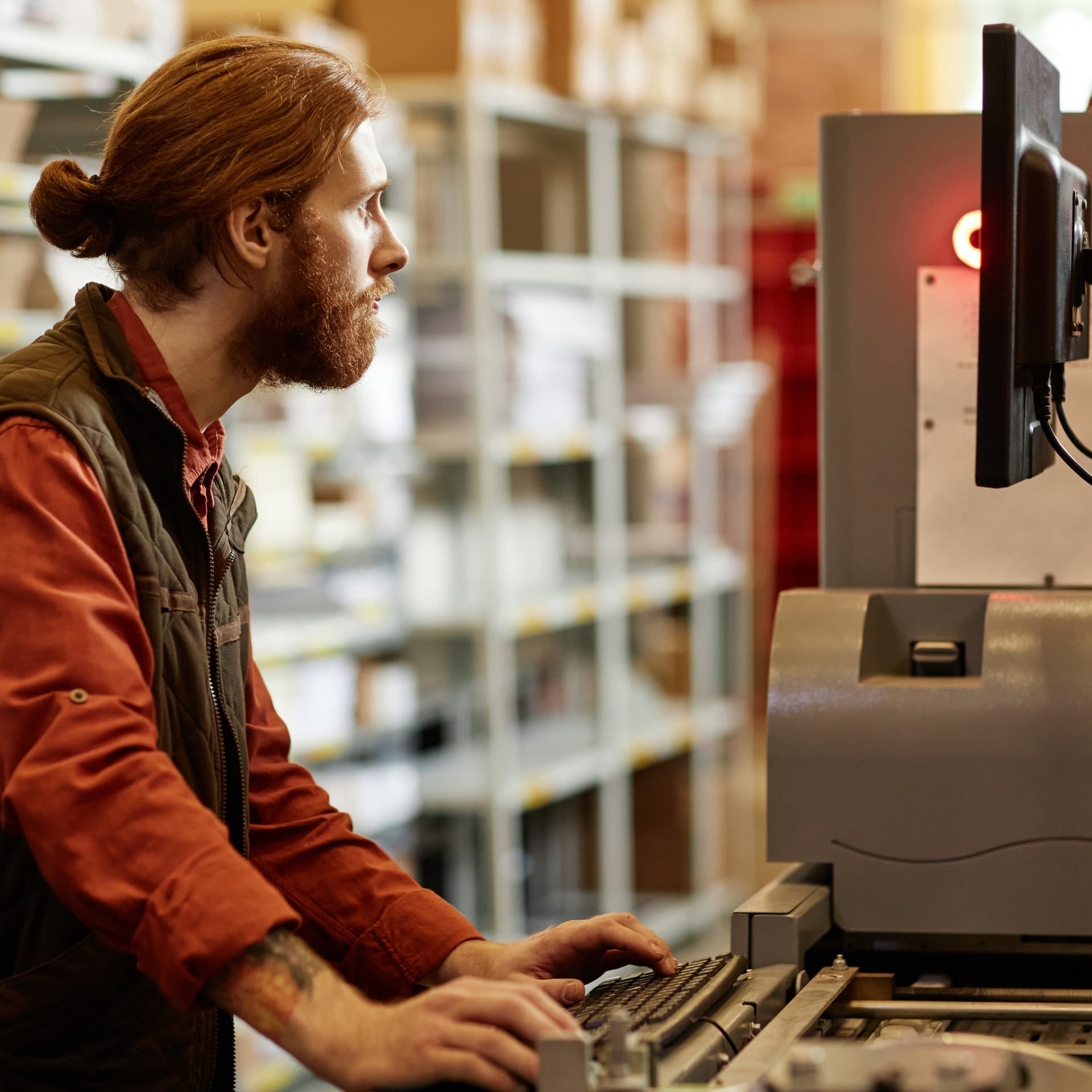 Side view of an employee working at a standing desk. Side view of an employee working at a standing desk.