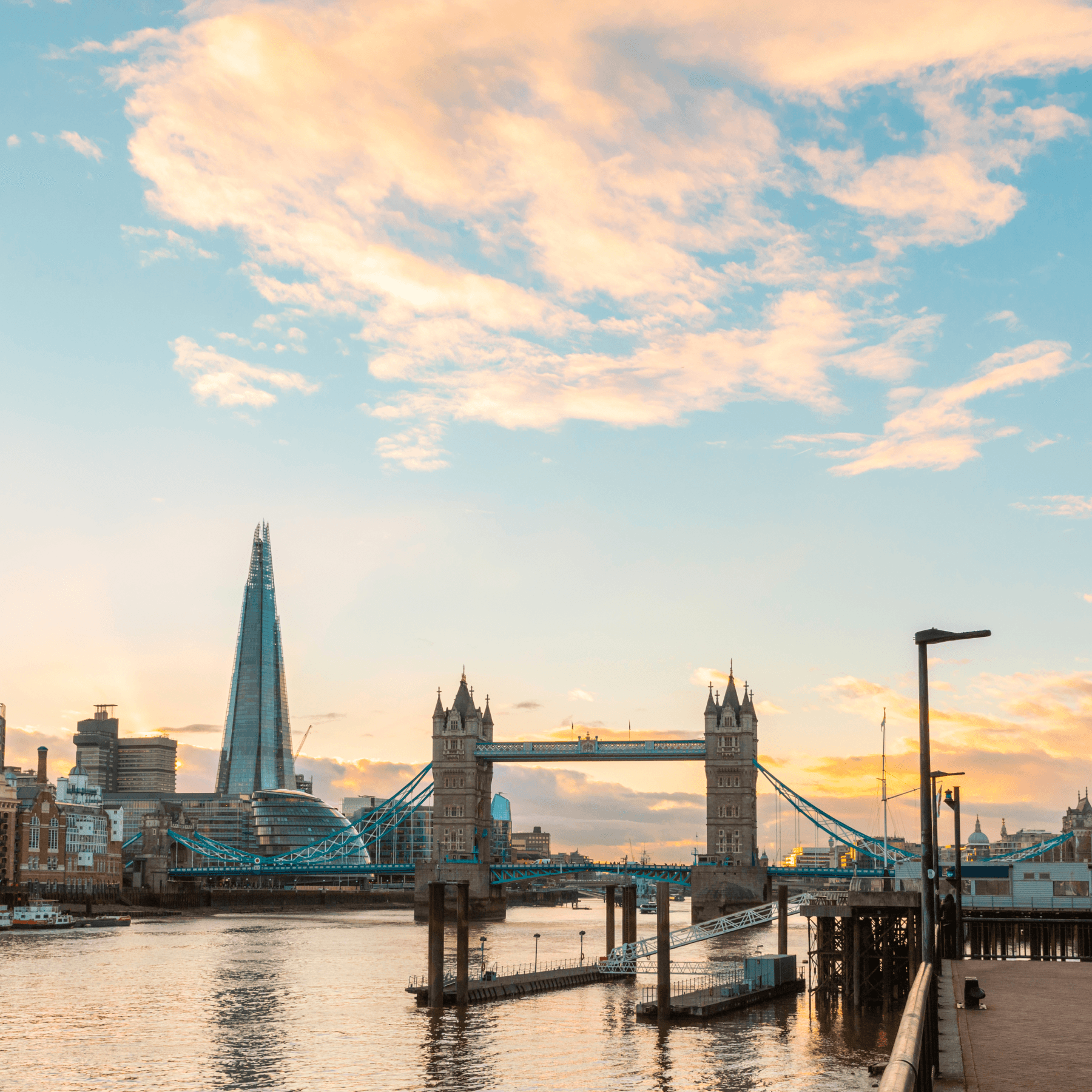 A bridge across a river in London with the Shard in background. A bridge across a river in London with the Shard in background.