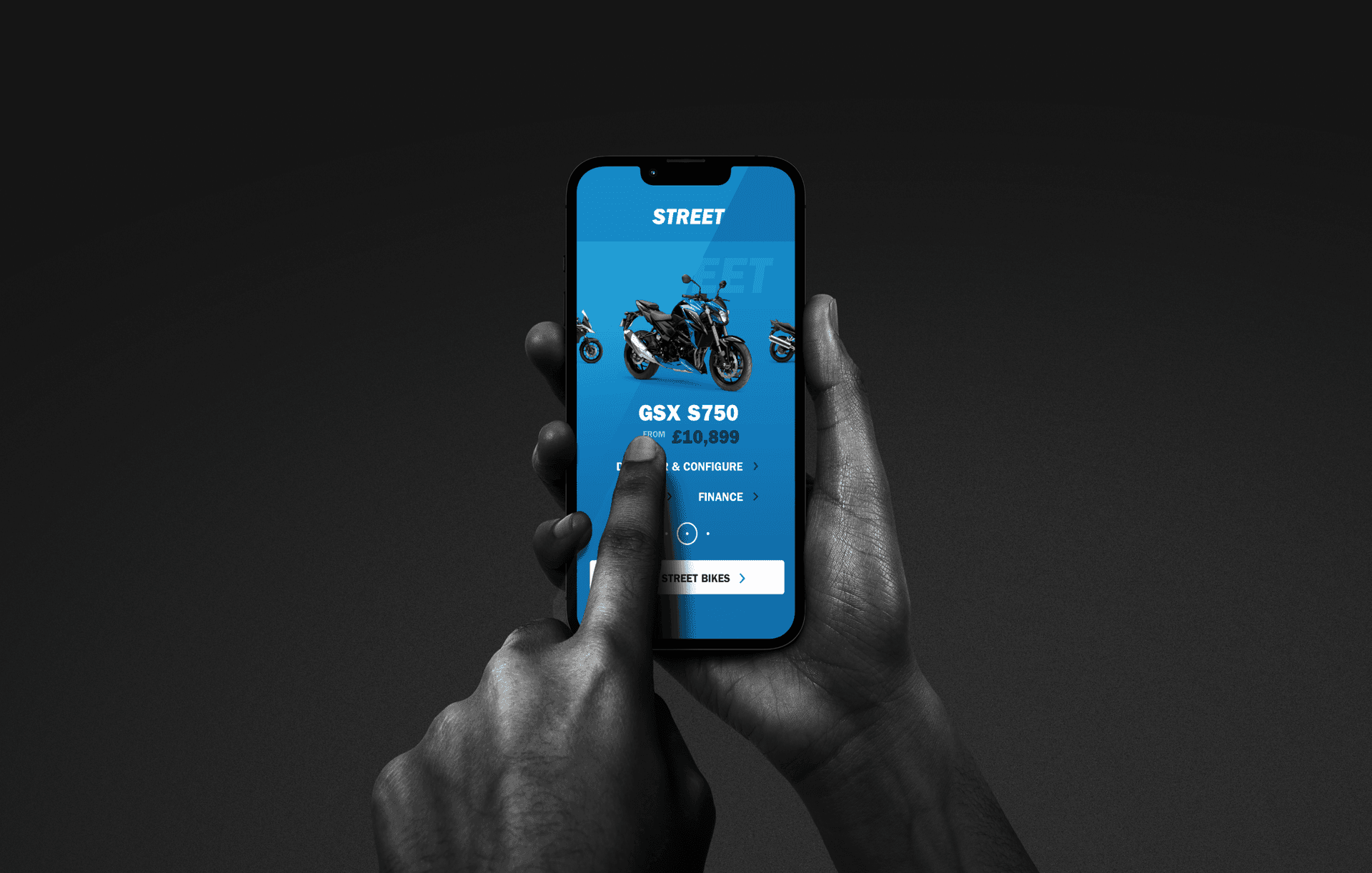 A person using a mobile to view a Suzuki motorcycle. A person using a mobile to view a Suzuki motorcycle.