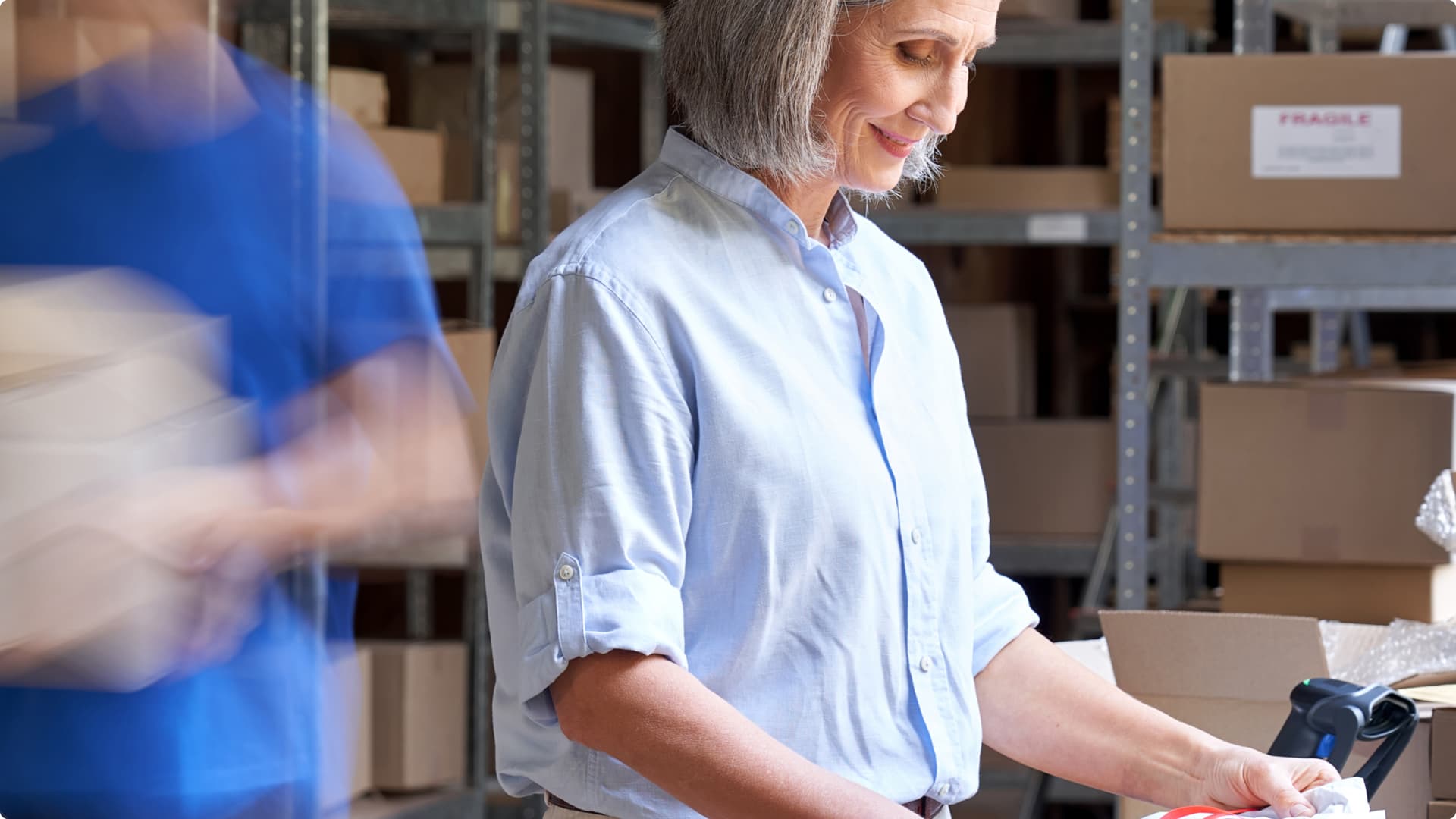 A woman is working on a packing line in a retail warehouse. A woman is working on a packing line in a retail warehouse.