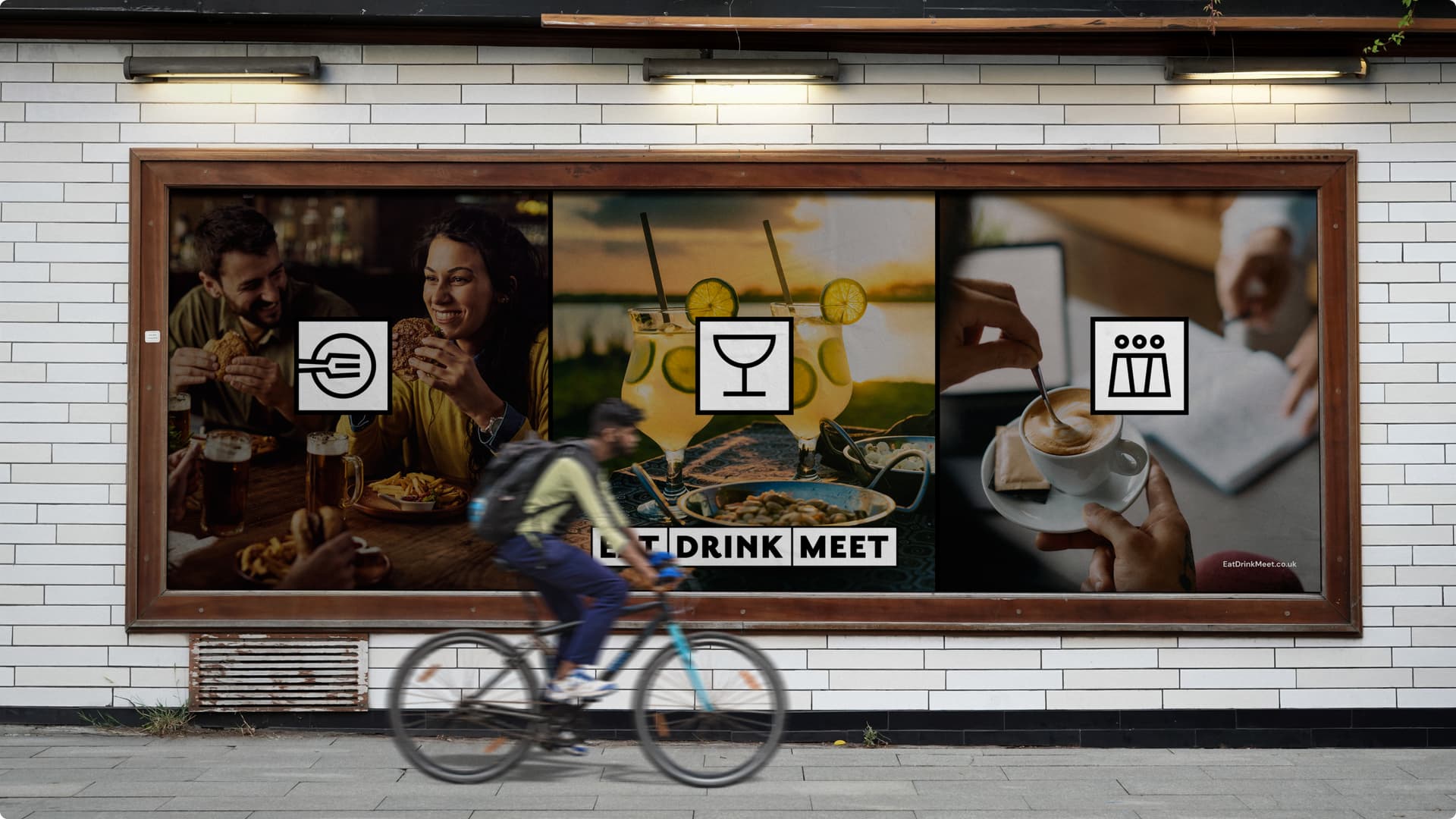 A man riding a bicycle in front of a billboard. A man riding a bicycle in front of a billboard.