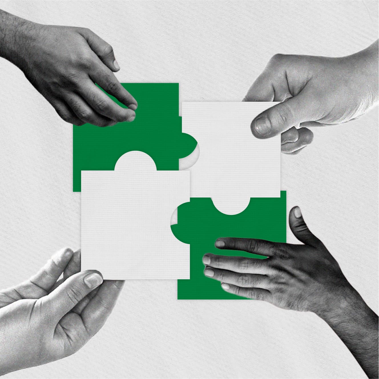 Four hands each holding a jigsaw puzzle. Four hands each holding a jigsaw puzzle.