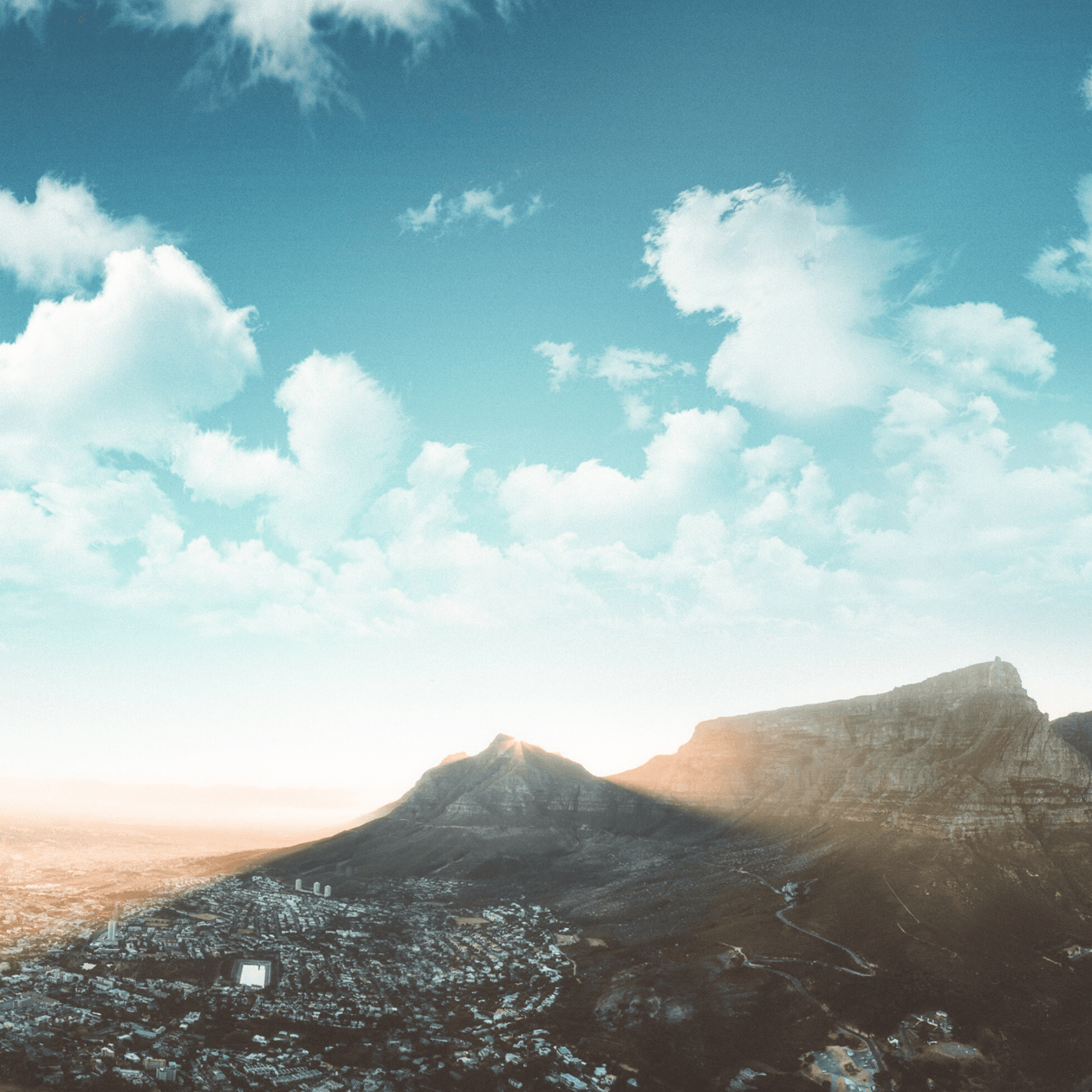 A mountain with clouds and blue sky. A mountain with clouds and blue sky.