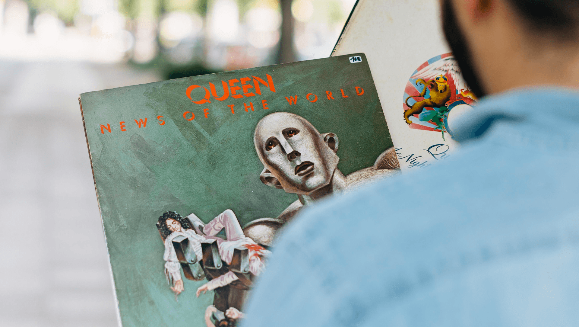 View over a person's shoulder showing a magazine with abstract art on the cover View over a person's shoulder showing a magazine with abstract art on the cover