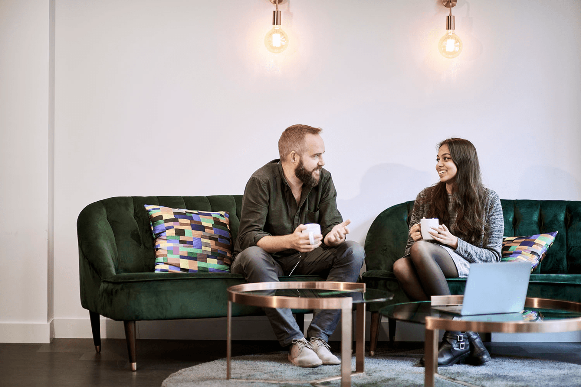 Two people having a discussion in an office together with a cup of tea. Two people having a discussion in an office together with a cup of tea.