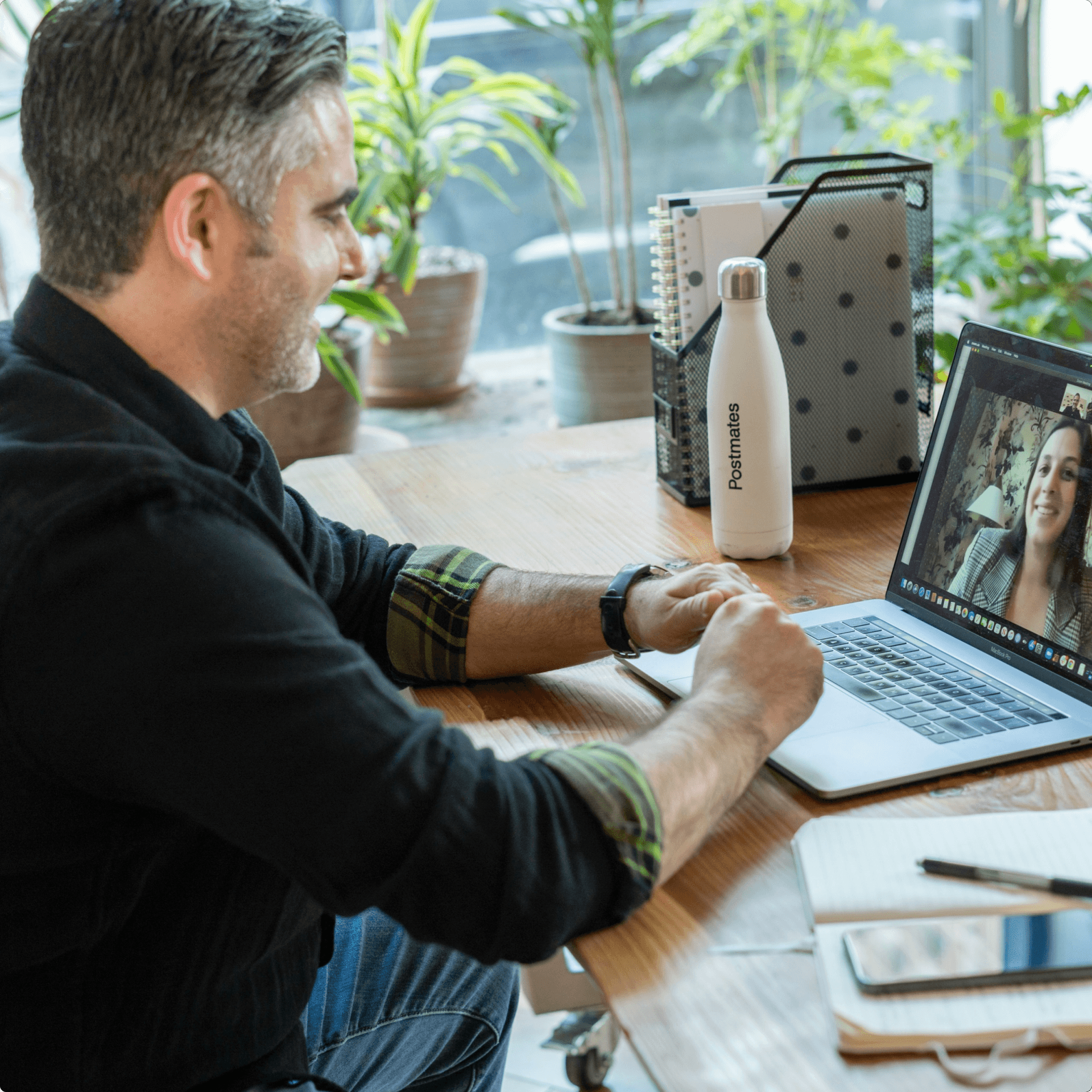 Man sitting at a desk having a video call on his laptop Man sitting at a desk having a video call on his laptop